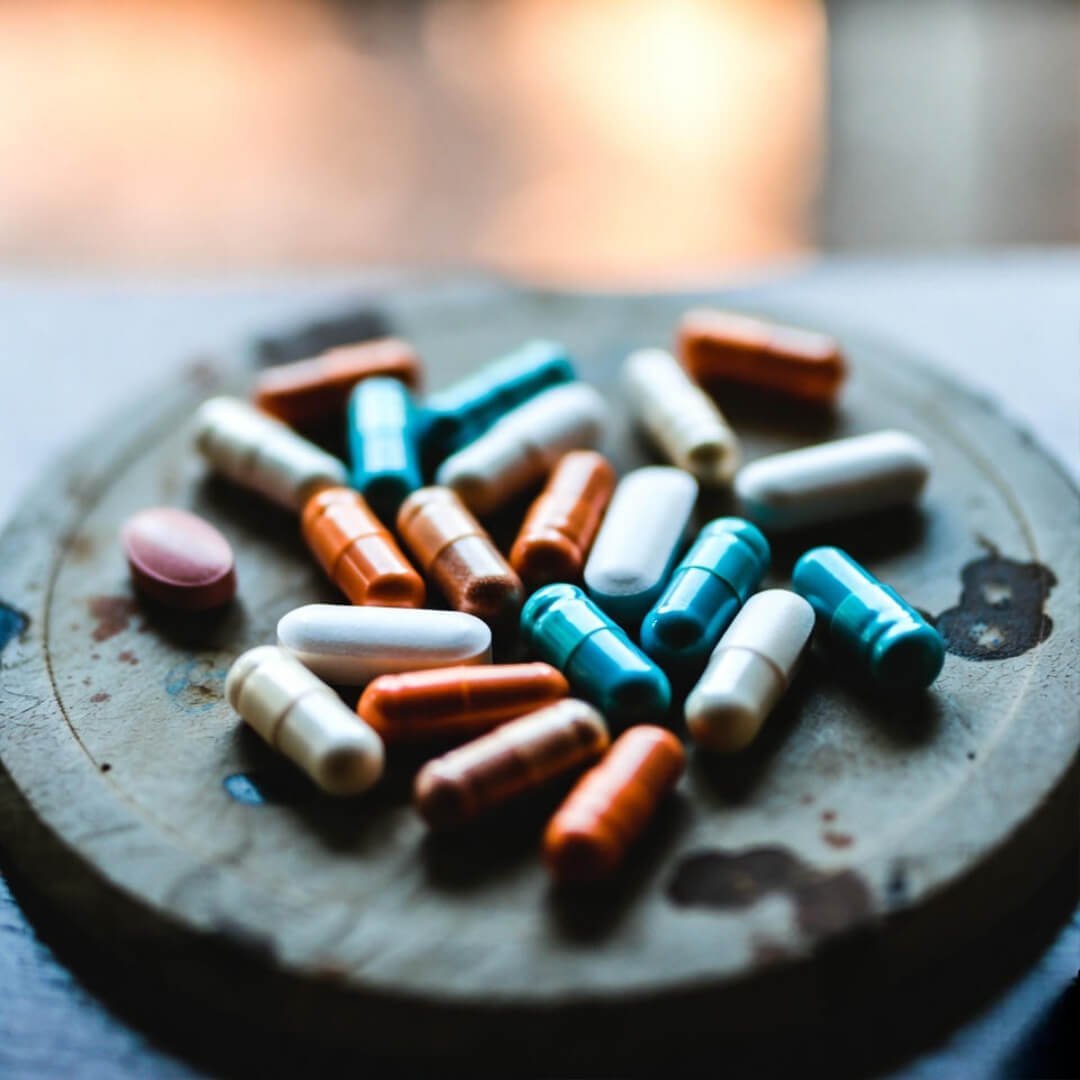 Immune-Boosting Supplements for Everyday Health Gummy vitamins spilled chaotically on rainy kitchen floor, phone dropped in dismay.