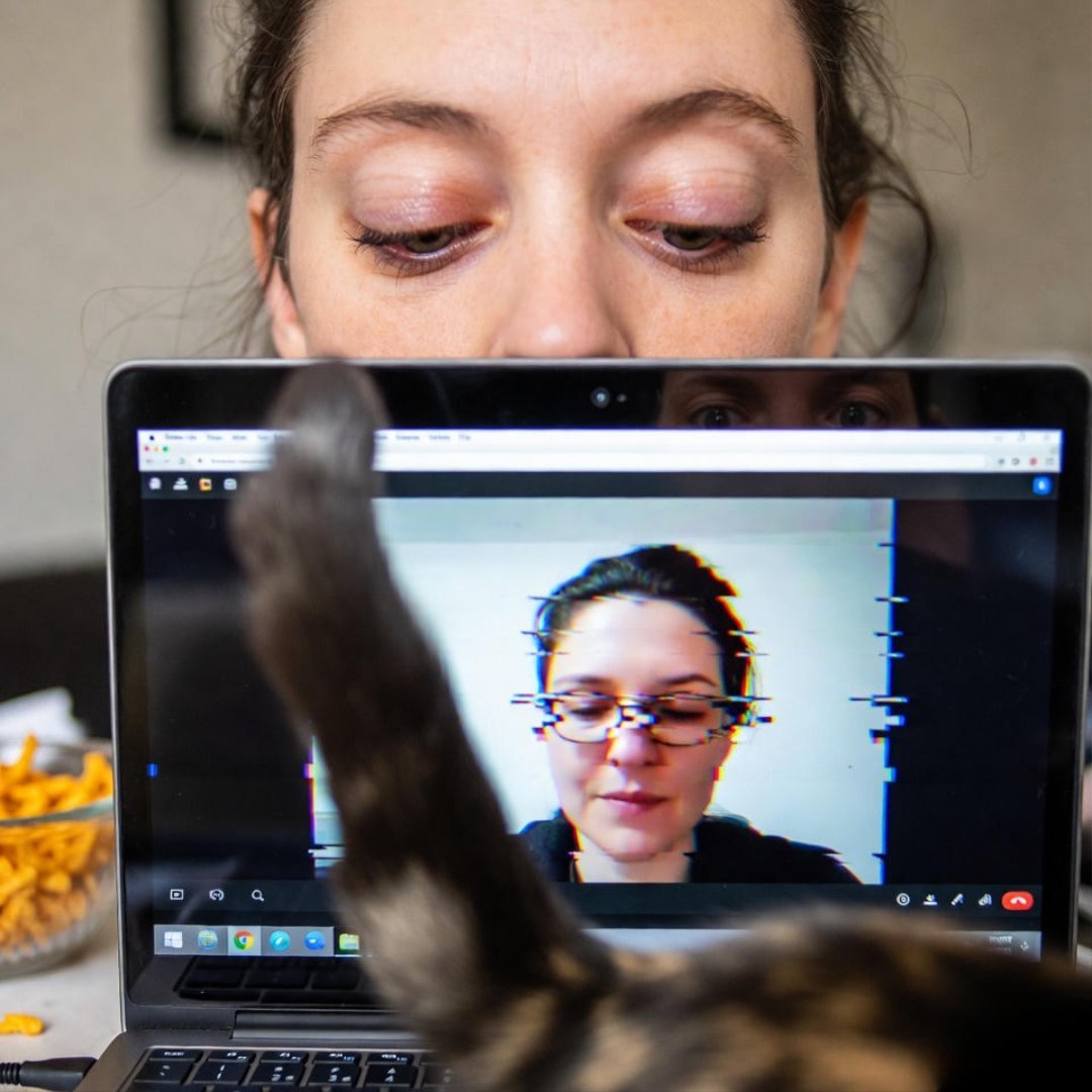 Glitched online therapy session: tired eyes, cat tail, Cheetos chaos. Glitched online therapy session: tired eyes, cat tail, Cheetos chaos.