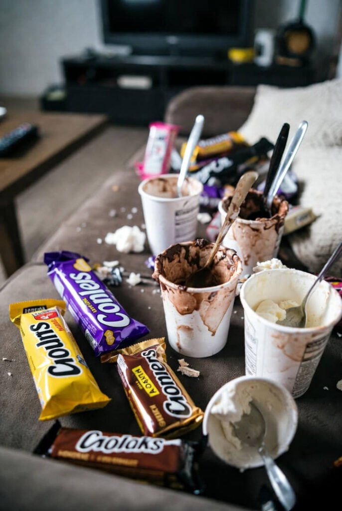 "Guilty late-night couch snacks, half-eaten candy and ice cream"