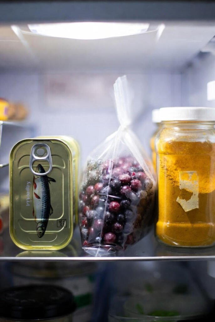 Fridge shelf: banged-up can and freezer frost
